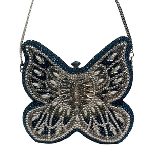 Macro detail of high-end butterfly clutch with gradient rhinestones and pearl beads