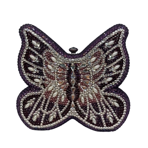 Macro detail of high-end butterfly clutch bag with deep purple and silver rhinestones