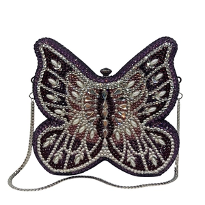 Detail of purple butterfly clutch bag featuring rhinestones, pearls and silver chain strap