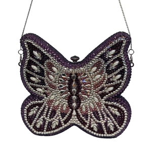 Detail of butterfly clutch bag featuring purple crystals and teardrop pearls