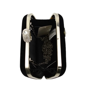 Detail view of open black velvet evening bag with silver chain strap and crystal ball clasp