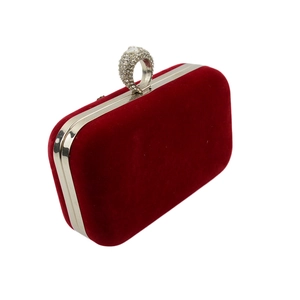 Macro shot of burgundy velvet evening clutch with sparkling silver rhinestone ring clasp