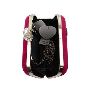 Top view of fuchsia velvet evening bag with silver rhinestone ring handle and chain