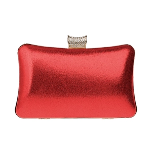 Macro view of metallic red evening clutch featuring a sparkling rhinestone encrusted lock