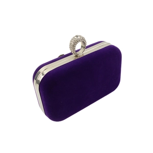 Detail of purple velvet evening clutch with sparkling crystal-encrusted ring handle
