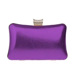 Macro view of purple metallic glitter evening bag with rhinestone-encrusted gold clasp