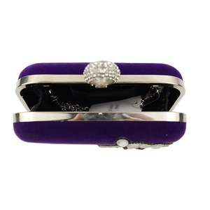 Detailed top view of purple velvet evening clutch with crystal lock and chain