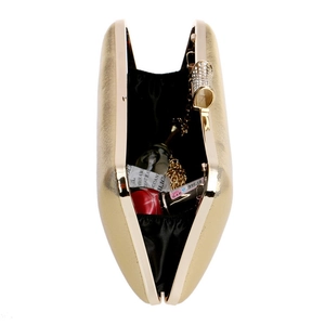 Detail view of gold clutch bag with rhinestone bow clasp showing internal storage space