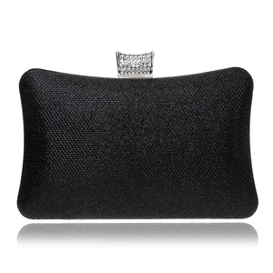 Close-up of black glitter evening bag featuring a rhinestone-encrusted metal clasp detail