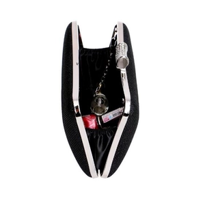Detail of black evening clutch showing bow rhinestone clasp and interior storage capacity