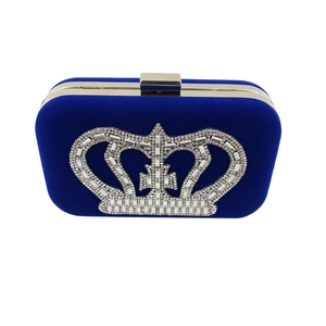 Detail of royal blue velvet evening clutch featuring a sparkling rhinestone crown design