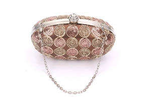 Detail of oval evening clutch with sequins, gold embroidery and rhinestone clasp