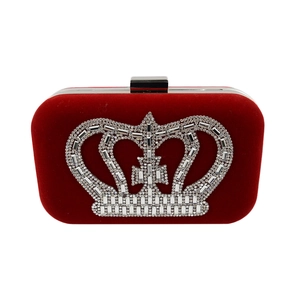 Detailed view of luxury burgundy velvet evening clutch with sparkling rhinestone crown motif