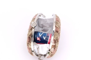 Detailed interior view of rose gold sequin clutch bag showing storage space and chain