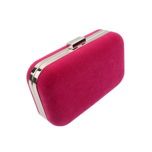 Detailed view of the fuchsia velvet evening clutch bag with elegant silver metal frame