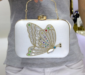 Detail of crystal butterfly evening bag with colorful rhinestones and gold metal handle