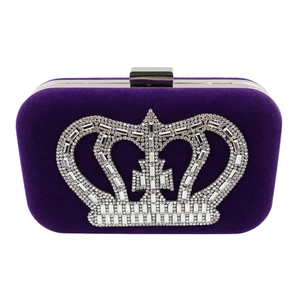 Close-up of purple velvet evening clutch featuring a sparkling rhinestone crown pattern
