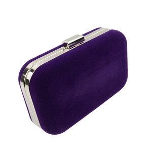 Detail of elegant purple velvet clutch bag with silver metal frame and clasp