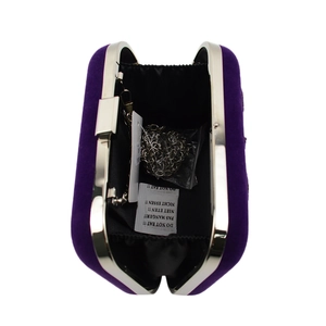 Top view of open purple velvet clutch bag with silver metal frame and chain strap