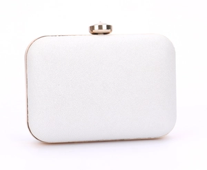Close-up of white leather evening clutch featuring a gold frame and crystal clasp