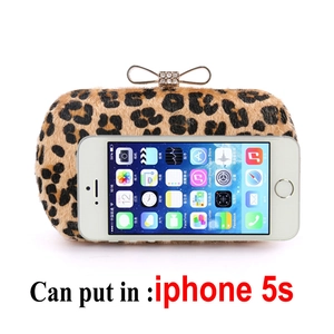 Leopard print clutch bag with crystal bow clasp shown next to a phone for size reference