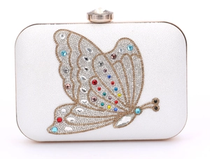 Macro shot of white crystal evening clutch bag with sparkling diamond butterfly embroidery