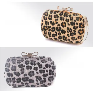 Detail of leopard print evening clutch bags in apricot and grey with diamond bow clasps