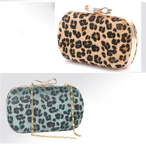 Detail of leopard print evening bags with crystal bow clasps and gold chain straps