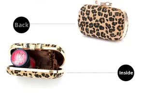 Detail view of leopard print clutch showing rhinestone bow clasp and gold chain strap