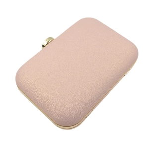 Detailed top view of a rose gold glitter evening clutch with elegant gold metal frame