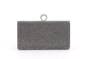 Detail of evening clutch featuring silver rhinestones and pearl ring clasp