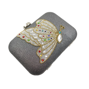 Detail of grey sparkling evening clutch bag featuring a colorful crystal butterfly motif