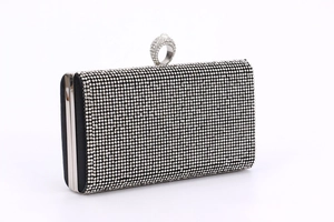 Detailed view of black rhinestone evening clutch featuring a crystal ring clasp