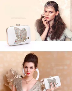 Detail of white evening clutch with colorful crystal butterfly and gold metal frame