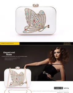 Detailed view of white leather clutch bag with crystal butterfly and gold chain strap