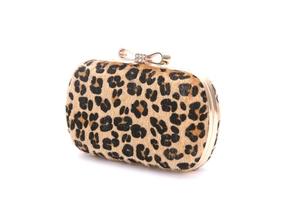 Detail of evening clutch featuring leopard print pony hair and rhinestone bow clasp