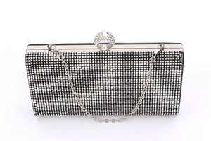 Detail of black mermaid clutch bag with rhinestones and ring-shaped silver clasp