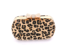 Detail of leopard print clutch with rhinestone bow clasp and gold metal frame