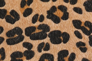 Detailed close-up of premium leopard print faux fur texture with soft short-pile fiber