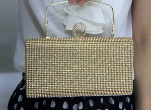 Detailed view of golden mermaid evening clutch with sparkling rhinestones and ring handle