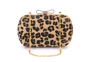 Detailed view of leopard print evening clutch with gold bow clasp and crystal accents