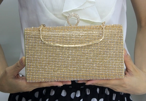 Elegant gold crystal mermaid clutch bag with rhinestone ring handle and metal chain strap