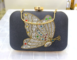 Close-up of black leather clutch featuring a vibrant multi-color crystal butterfly design