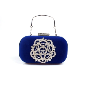 Détail de la pochette en velours bleu marine avec strass floraux et poignée argentée