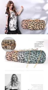 Detail of leopard print evening clutch featuring diamond bow clasp and metal chain strap