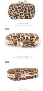 Macro view of leopard print evening clutch with gold bow clasp and crystal accents