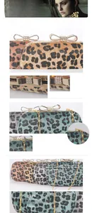 Detail of leopard print evening clutch with crystal bow clasp and gold chain strap