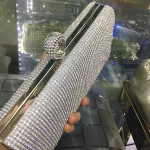 Detailed view of silver rhinestone clutch with luxury crystal ball clasp and metal frame