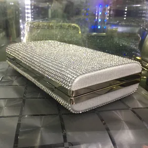 Macro detail of silver clutch bag with sparkling crystals and metal frame