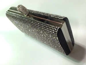 Detailed view of luxury silver evening clutch with white rhinestones and ring clasp